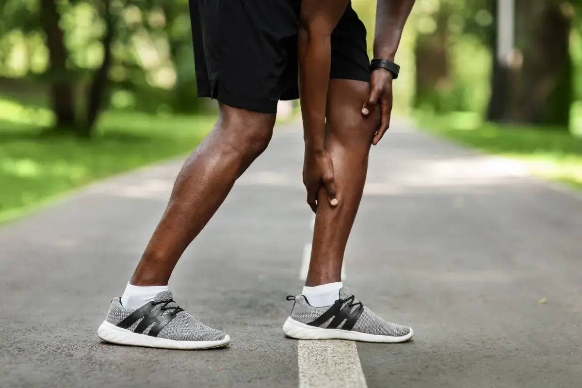 Older man stopping on a walk with calf pain, a common symptom of peripheral artery disease